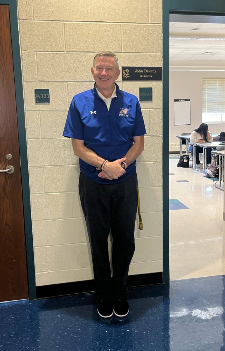 Mr. Devany outside of his classroom on his last day.