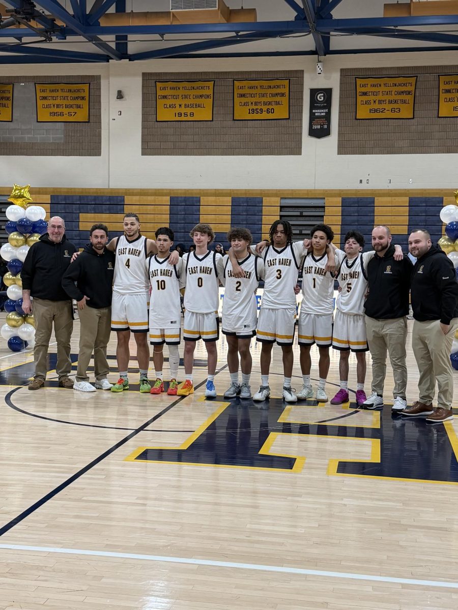 Senior boys gather to take a photo with their coaches during the ceremony. 